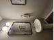 Modern half-bathroom with a pedestal sink, unique lighting, and stylish mirror for guests at 1132 Red Bud Cir, Villa Rica, GA 30180