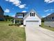 Charming white two-story home with black shutters and a well-manicured front lawn at 1132 Red Bud Cir, Villa Rica, GA 30180