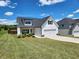 Charming white two-story home featuring a well-manicured lawn, black shutters, and an attached garage at 1132 Red Bud Cir, Villa Rica, GA 30180