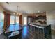 Well-lit kitchen featuring dark wood cabinets, granite countertops, an island with seating, and stainless appliances at 1132 Red Bud Cir, Villa Rica, GA 30180
