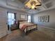Comfortable bedroom with a tray ceiling, neutral color scheme, and large windows for natural light, a peaceful retreat at 1132 Red Bud Cir, Villa Rica, GA 30180