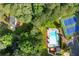 An aerial view showcasing a community pool and tennis courts surrounded by trees at 2789 Brookcliff Lndg, Marietta, GA 30062