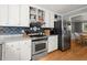 Kitchen area with stainless steel appliances, white cabinets, and hardwood floors at 2789 Brookcliff Lndg, Marietta, GA 30062
