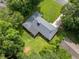Aerial view of home showing roof, lawn, mature trees, and driveway at 4062 Plantation Dr, Marietta, GA 30062