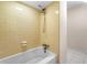 Bathtub featuring yellow tile surround and shower head at 4062 Plantation Dr, Marietta, GA 30062