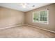 Neutral bedroom with a large window, carpet flooring, and natural light at 4062 Plantation Dr, Marietta, GA 30062