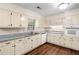 Well-lit kitchen with white cabinetry, stone countertops, and modern appliances at 4062 Plantation Dr, Marietta, GA 30062