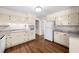 Bright kitchen featuring white cabinetry, modern countertops, and durable wood-look flooring at 4062 Plantation Dr, Marietta, GA 30062