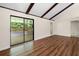 Open living room with beamed ceilings and sliding glass doors to an outdoor patio at 4062 Plantation Dr, Marietta, GA 30062