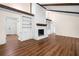 Spacious living room featuring high ceilings, hardwood floors, and a charming brick fireplace at 4062 Plantation Dr, Marietta, GA 30062