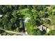 Aerial view showcasing the home's private, wooded lot and long driveway approach at 48 Old Canton Ne Rd, Cartersville, GA 30121