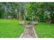 Spacious backyard featuring a swing set and fire pit, perfect for outdoor entertaining at 48 Old Canton Ne Rd, Cartersville, GA 30121