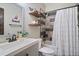 Charming bathroom featuring rustic wood shelves, gray vanity, and stylish shower curtain at 48 Old Canton Ne Rd, Cartersville, GA 30121