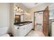 Bright bathroom boasts dual sinks, granite countertops, a doorway to bedroom, and modern lighting at 48 Old Canton Ne Rd, Cartersville, GA 30121