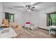 Bright bedroom with two beds, a ceiling fan, and scenic window views at 48 Old Canton Ne Rd, Cartersville, GA 30121