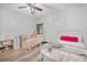 Bright bedroom features two twin beds, a desk, modern ceiling fan, and wood-look flooring at 48 Old Canton Ne Rd, Cartersville, GA 30121