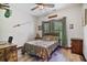 Comfortable bedroom with hardwood floors, a ceiling fan, and a wood-framed bed with camouflage bedding at 48 Old Canton Ne Rd, Cartersville, GA 30121