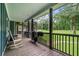 Relaxing covered porch with rocking chair offers a scenic view of the expansive yard at 48 Old Canton Ne Rd, Cartersville, GA 30121