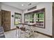 Charming dining area with bright windows and a view to a screened in outdoor space at 48 Old Canton Ne Rd, Cartersville, GA 30121