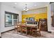 Bright dining room featuring wood floors, stylish accent wall and large window at 48 Old Canton Ne Rd, Cartersville, GA 30121