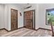 Welcoming entryway showcasing a rustic wooden door, natural light, and stylish wood flooring at 48 Old Canton Ne Rd, Cartersville, GA 30121