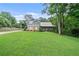 Charming two-story home with a metal roof, landscaped yard, and a welcoming front porch at 48 Old Canton Ne Rd, Cartersville, GA 30121