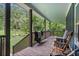 Charming front porch with wood floors, a ceiling fan, and rocking chairs overlooking a green yard at 48 Old Canton Ne Rd, Cartersville, GA 30121