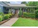 Charming home featuring a welcoming front porch with wooden columns and manicured landscaping at 48 Old Canton Ne Rd, Cartersville, GA 30121