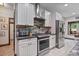 Modern kitchen featuring stainless steel appliances, ample counter space, and stylish white cabinetry at 48 Old Canton Ne Rd, Cartersville, GA 30121