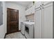 Well-organized laundry room with modern appliances, white cabinetry, and a convenient layout at 48 Old Canton Ne Rd, Cartersville, GA 30121
