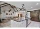 Open-concept living room showcasing a large kitchen island, rustic ceiling beams, and cozy seating area at 48 Old Canton Ne Rd, Cartersville, GA 30121