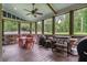The screened deck features a ceiling fan, wood flooring, and an outdoor table with a grill at 48 Old Canton Ne Rd, Cartersville, GA 30121