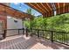 Lovely back deck with wood-style floor, black railing, and striped sun shade with hanging lights at 1029 Fairway Ne Ests, Atlanta, GA 30319