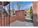 Courtyard with a brick privacy fence, metal gate, brick steps and partial view of homes at 1029 Fairway Ne Ests, Atlanta, GA 30319
