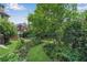 Backyard featuring lush landscaping, a stone terrace, manicured lawn, and partial view of homes at 1029 Fairway Ne Ests, Atlanta, GA 30319