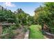 Beautiful backyard featuring lush landscaping, a stone terrace, and manicured lawn at 1029 Fairway Ne Ests, Atlanta, GA 30319