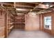 Basement room with exposed ceiling, brick walls, built-in shelving, and one window at 1029 Fairway Ne Ests, Atlanta, GA 30319