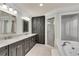 Modern bathroom features double sinks, soaking tub, shower, and ample storage, creating a spa-like retreat at 1029 Fairway Ne Ests, Atlanta, GA 30319