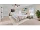 Bright bedroom features stylish mirrored dresser, ceiling fan, ensuite bathroom, and a luxurious queen bed with a white shag rug at 1029 Fairway Ne Ests, Atlanta, GA 30319