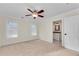 Bright bedroom features neutral carpet, ceiling fan, and ensuite bathroom, offering a serene space at 1029 Fairway Ne Ests, Atlanta, GA 30319