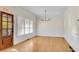 Inviting dining room features natural light from shuttered windows and a modern chandelier at 1029 Fairway Ne Ests, Atlanta, GA 30319