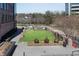 The fenced dog park and lawn is located next to the building and landscaped walking area at 1029 Fairway Ne Ests, Atlanta, GA 30319