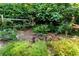Charming garden bed with a variety of plants, a wooden fence, and natural mulch for a tranquil ambiance at 1029 Fairway Ne Ests, Atlanta, GA 30319