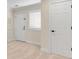 Hallway featuring a window with plantation shutters and white painted trim and neutral carpet at 1029 Fairway Ne Ests, Atlanta, GA 30319