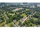 Expansive aerial view of neighborhood, showcasing proximity to schools, parks, and community amenities in a lush, green setting at 47 Powder Springs St, Hiram, GA 30141