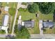 Aerial view of a well-maintained property with lush greenery, a long driveway, and two outbuildings at 47 Powder Springs St, Hiram, GA 30141