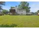 Backyard features a screened porch, mature trees, and a large grassy area at 47 Powder Springs St, Hiram, GA 30141