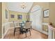 Bright dining room featuring a glass table, chandelier, and large window with natural light at 47 Powder Springs St, Hiram, GA 30141