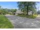 Long concrete driveway with a carport, fenced yard and well-maintained lawn at 47 Powder Springs St, Hiram, GA 30141