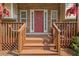 Front entry with brick accents and wooden porch at 47 Powder Springs St, Hiram, GA 30141